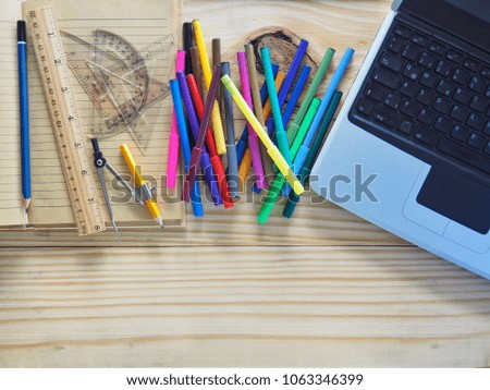 Computers, pencils, notebooks and drawing tools on wooden boards. Meaning of design work. New Graphic Creation and Concepts