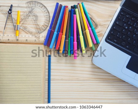 Computers, pencils, notebooks and drawing tools on wooden boards. Meaning of design work. New Graphic Creation and Concepts
