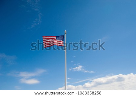 American Flag waving with wind in Country side of America. 