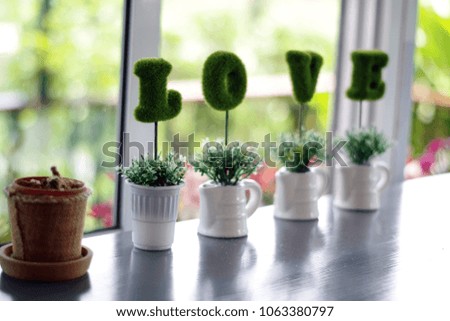 Love letters made of velvet embroidered in cups. and cactus on wooden table natural background and soft focus