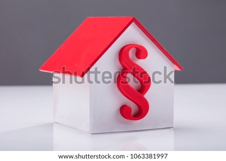 Close-up Of A House Model With Paragraph Symbol