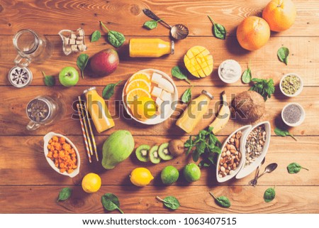 Fresh smoothie, Variety of fruits, leaves, seeds and berries on rustic wooden background, top view.  Clean eating, detox, dieting, vegetarian, vegan, fitness, healthy lifestyle concept