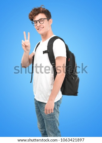 Happy young student with victory gesture