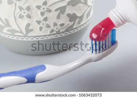 toothpaste and toothbrush on the white background.  
