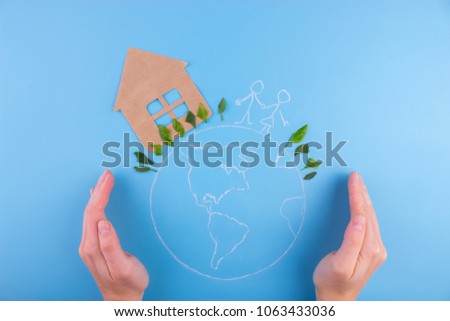 Environmental green energy concept. house and family on the earth planet