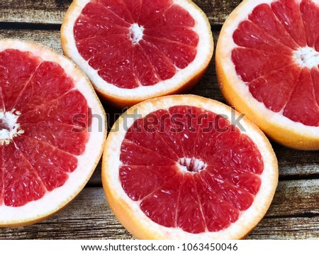 cutted grapefruit on wooden background. slidec grapefruits top view. juice grapefruit close up
