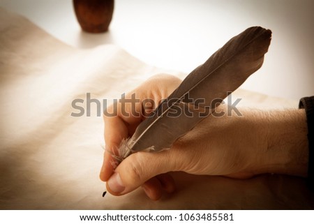 writer holds a fountain pen over writing paper and a signature closeup