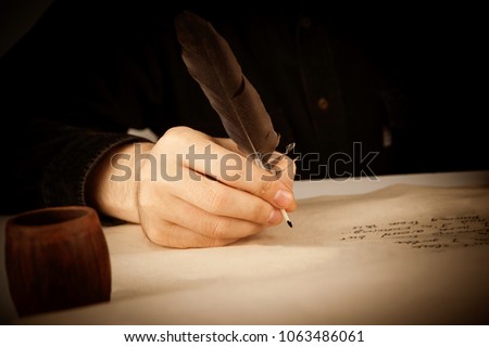 writer holds a fountain pen over writing paper and the writing poems