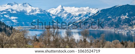 Panorama of Alps with Zell am See and lake Zeller. Spring panorama of  lake and Alps mountains in behind.