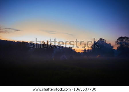 Summer landscape with camping and smog in blue twilight after sunset
