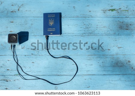 Passport usb and music loud speaker concept about travel, music and trips on blue background for copy or text