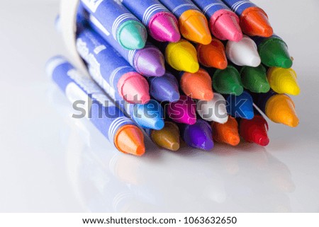 Colorful crayons in cup,white background
