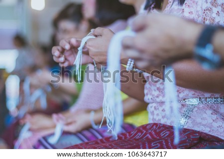 Handfasting. Selective focus on hands of Thai graduation ceremony.