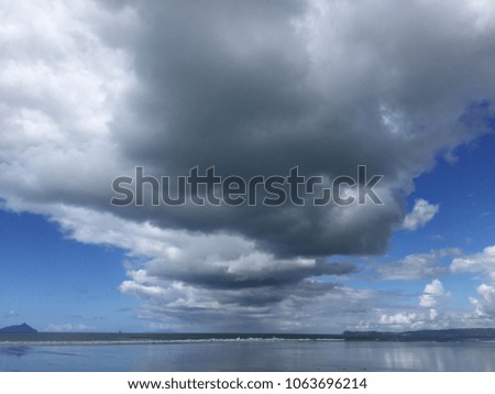 cumulous cloud front over shoreline
