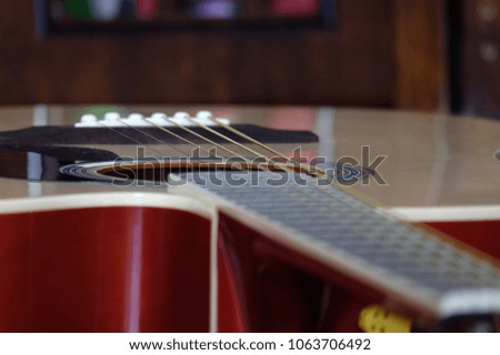Acoustic guitar selective focus on box strings