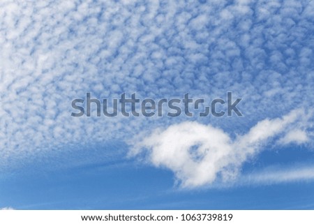 Blue sky background with white clouds and sunlight in the sky