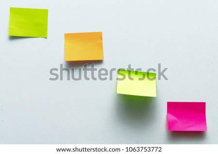 Blank sticker label isolated on the white wall surface background with copy space. To do list. Plans.