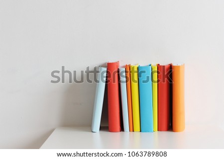 Multi-colored books on a white background