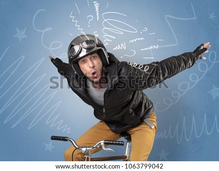 Young foolish crazy rider with doodle on the background