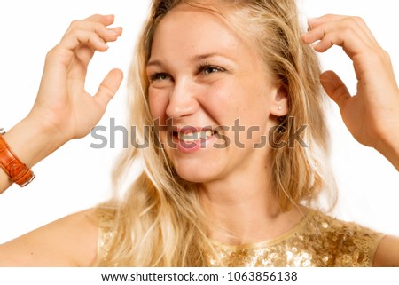 Beautiful young blonde laughing, hands near the head