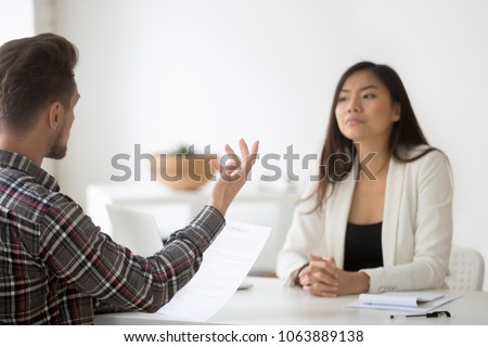 Disgruntled employee or angry client complaining on bad contract demanding compensation at meeting with asian lawyer, disagreeing with chinese partner listening claims about document, fraud concept Royalty-Free Stock Photo #1063889138