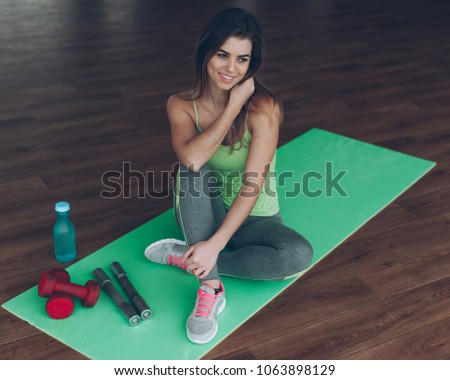 slender sports girl in the gym, athletic gear