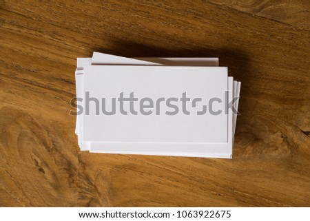Top view image of stack of business card on wooden table background