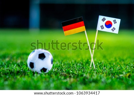 Germany - Korea Republic, South Korea, Group F, Wednesday, 27. June, Football, National Flags on green grass, white football ball on ground.