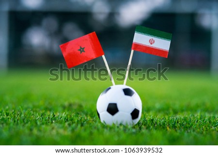 Morocco - IR Iran, Group B, Friday, 15. June, Football, National Flags on green grass, white football ball on ground. Royalty-Free Stock Photo #1063939532