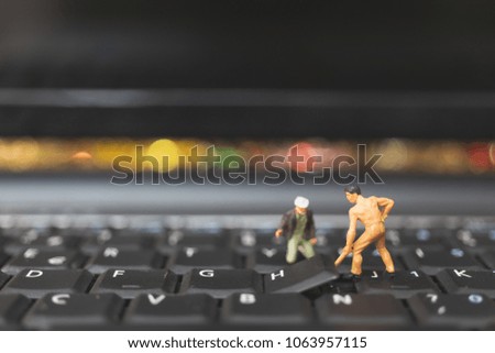Miniature people : Worker team of engineers repairing keyboard computer laptop. Computer repair concept.