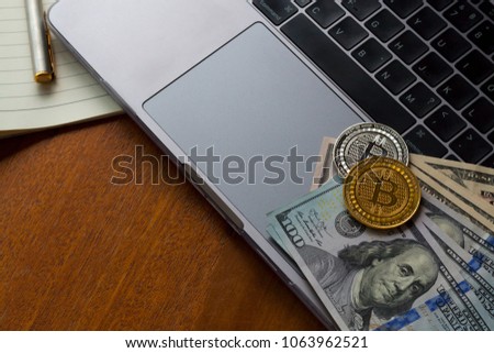 Bitcoin Crypto Carrency Blockchain Cryptocurrency Wallet digital Concept. Gold and silver  coin is located on dollar and computer. 