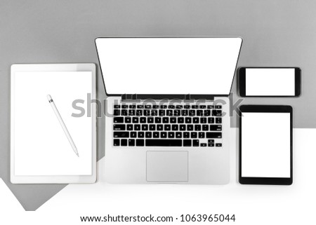 Office table with laptop computer, digital tablet, smartphone, pencil and mouse on isolated pure white background. Laptop and tablet mockup concept. (Monitor clipping path)(Selective Focus)