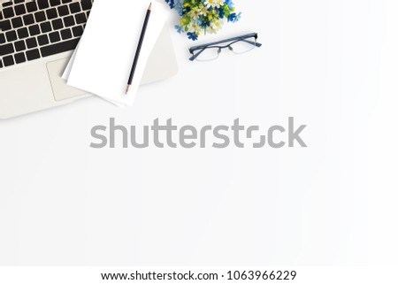 Office desk or workspace with laptop computer,smartphone and coffee cup with copy space on color background. Top view. Flat lay style.