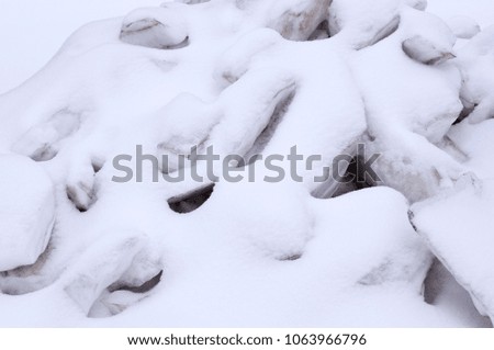 pile of melting ice blocks cowered with snow. seasonal, background, nature.
