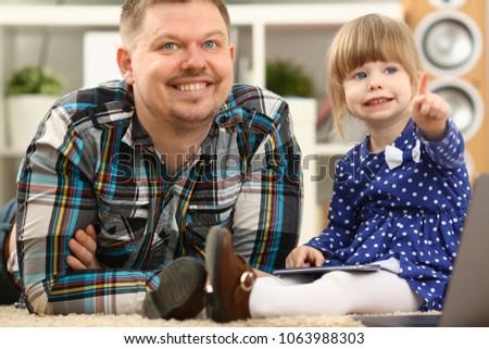 Cute little girl on floor carpet with dad use cellphone calling mom portrait. Life style apps social web network wireless ip telephony concept