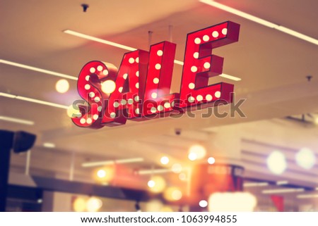 
Red metal signage shop lighting on shopping mall background