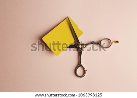 Mockup of yellow color credit card on empty pink desk. Business mock-up background for message writing.Top view. Horizontal