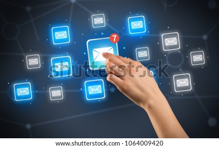 Female hand touching unread mail icon with more envelope icons around it 