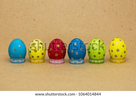 Multicolored easter eggs on beige background