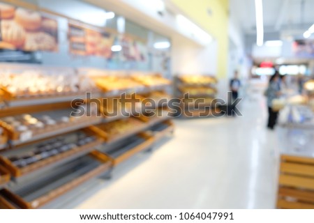 Blurred supermarket store background in shopping mall, stock of product on the shelves of whole foods, drinks, bread and bakery market.