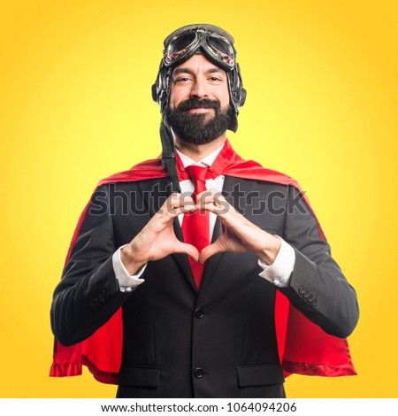 Super hero businessman making a heart with his hands