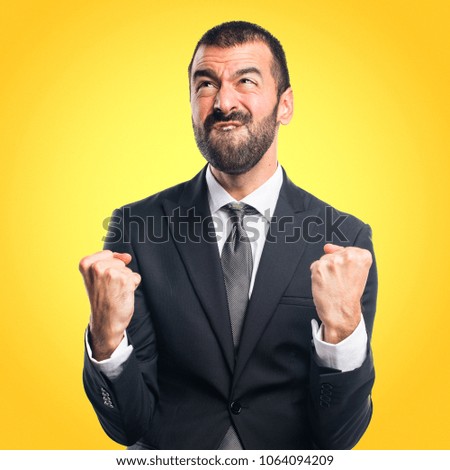 Lucky Businessman on yellow background