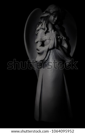 Soft Angel Statue Praying in the Dark in Black and White
