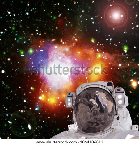 Closeup of astronaut. Colorful nebula and stars. The elements of this image furnished by NASA.