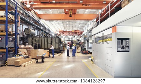 industrial factory in mechanical engineering for the manufacture of transformers - interior of a production hall  Royalty-Free Stock Photo #1064126297