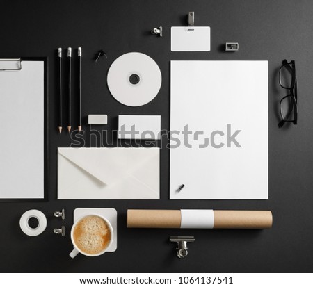 Blank stationery set on black paper background. Template for branding identity. For graphic designers presentations and portfolios. Top view. Flat lay.
