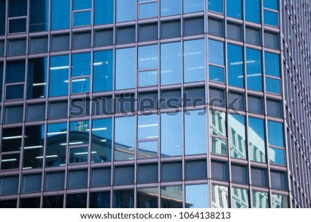 Reflections in an office building window. Blue sky and architecture.