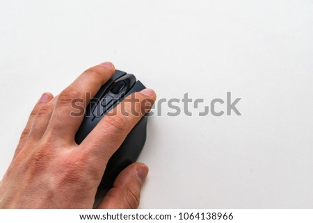 Left man's hand holding wireless black mouse, right button click, white background and smooth natural light and shadows