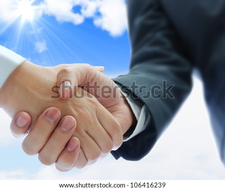 business people shaking hands on blue sky background Royalty-Free Stock Photo #106416239