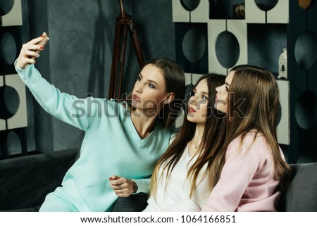  friendship, people  and technology concept - happy friends or teenage girls with smartphone taking selfie at home